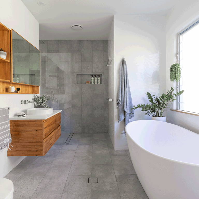 Luxurious Spa like ensuite in Bexhill, Lismore NSW featuring timber cabinetry and stone bath tub by Northern Rivers Bathroom Renovations.