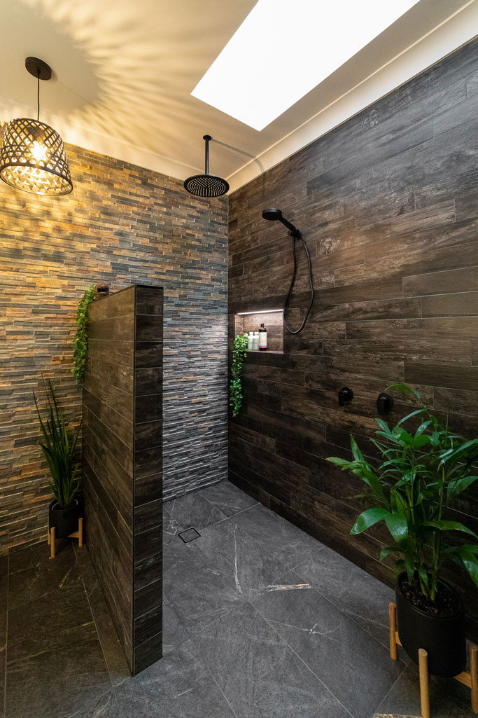 Wetroom ensuite in Alstonville NSW featuring stone stack tiles, black tapware & skylight
