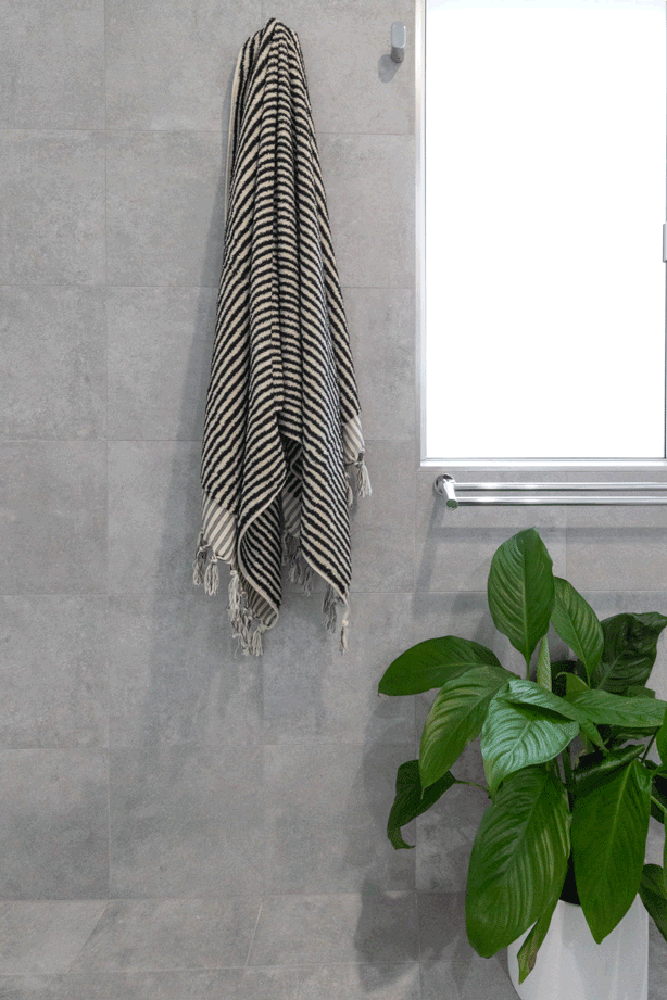Grey wall tiles with towel on wall hook in bathroom renovation , Ballina NSW