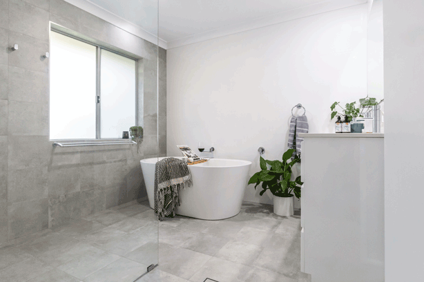 modern grey and white bathroom with freestanding bath tub in Ballina NSW by Northern Rivers Bathroom Renovations
