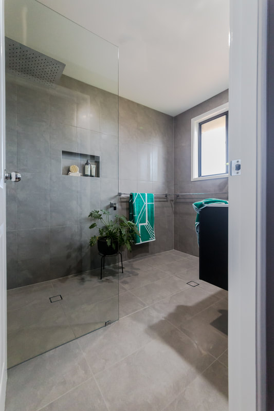 Bathroom renovation in Wollongbar NSW featuring grey porcelain wall and floor tiles and large walk in shower. Renovation by Northern Rivers Bathroom Renovations Lismore