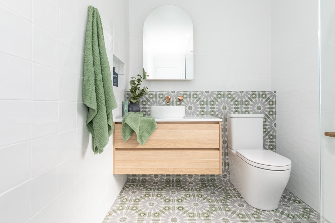 Vibrant Ensuite renovated by Northern Rivers Bathroom Renovations using oak laminate custom cabinetry, arch mirror cabinet, bold green and grey encaustic floor tiles and brushed copper tapware. 