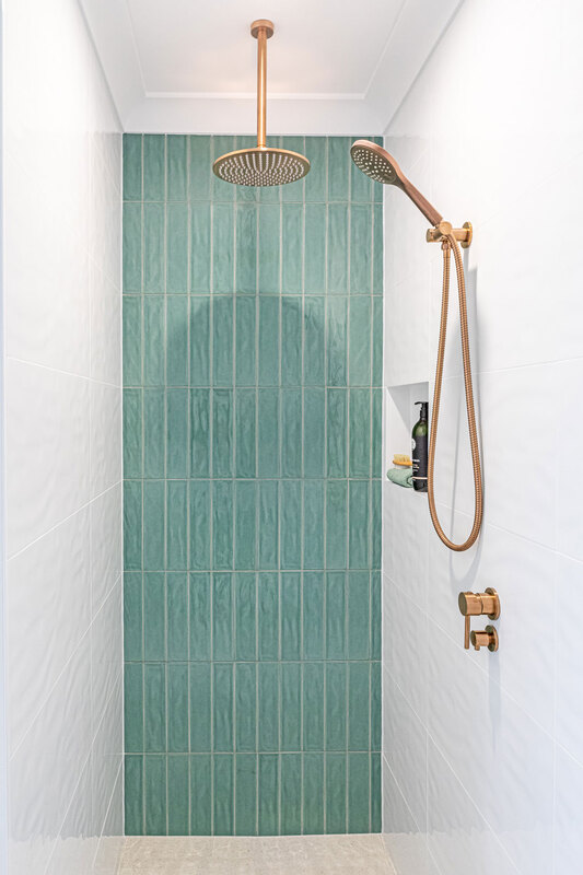 coastal bathroom style in Skennars Head bathroom renovation  by Northern Rivers Bathroom Renovations. featuring sage green subway tile in walk in shower with brushed copper overhead rain shower and brushed copper hand held rail shower.
