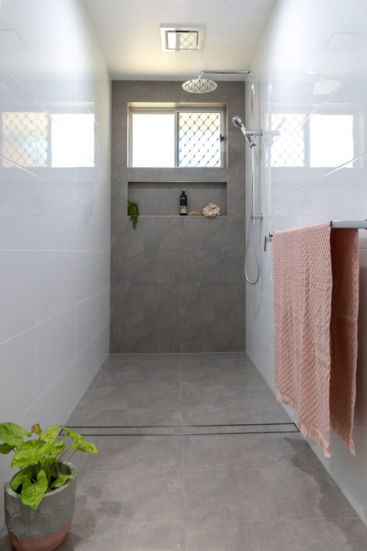 A grey and white open shower in a minimal wet room bathroom by Northern Rivers Bathroom Renovations in Wollongbar NSW